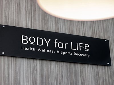 A sign on the wall that reads Body for Life