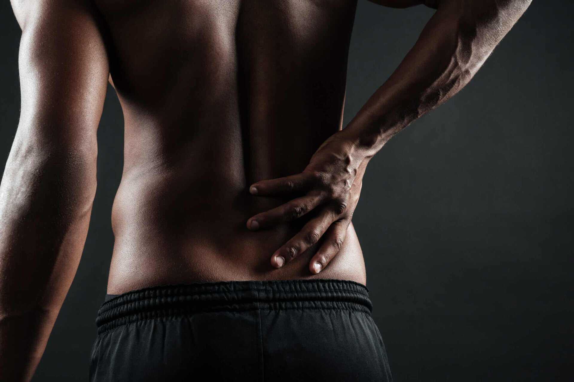 Man holding his lower back due to back pain