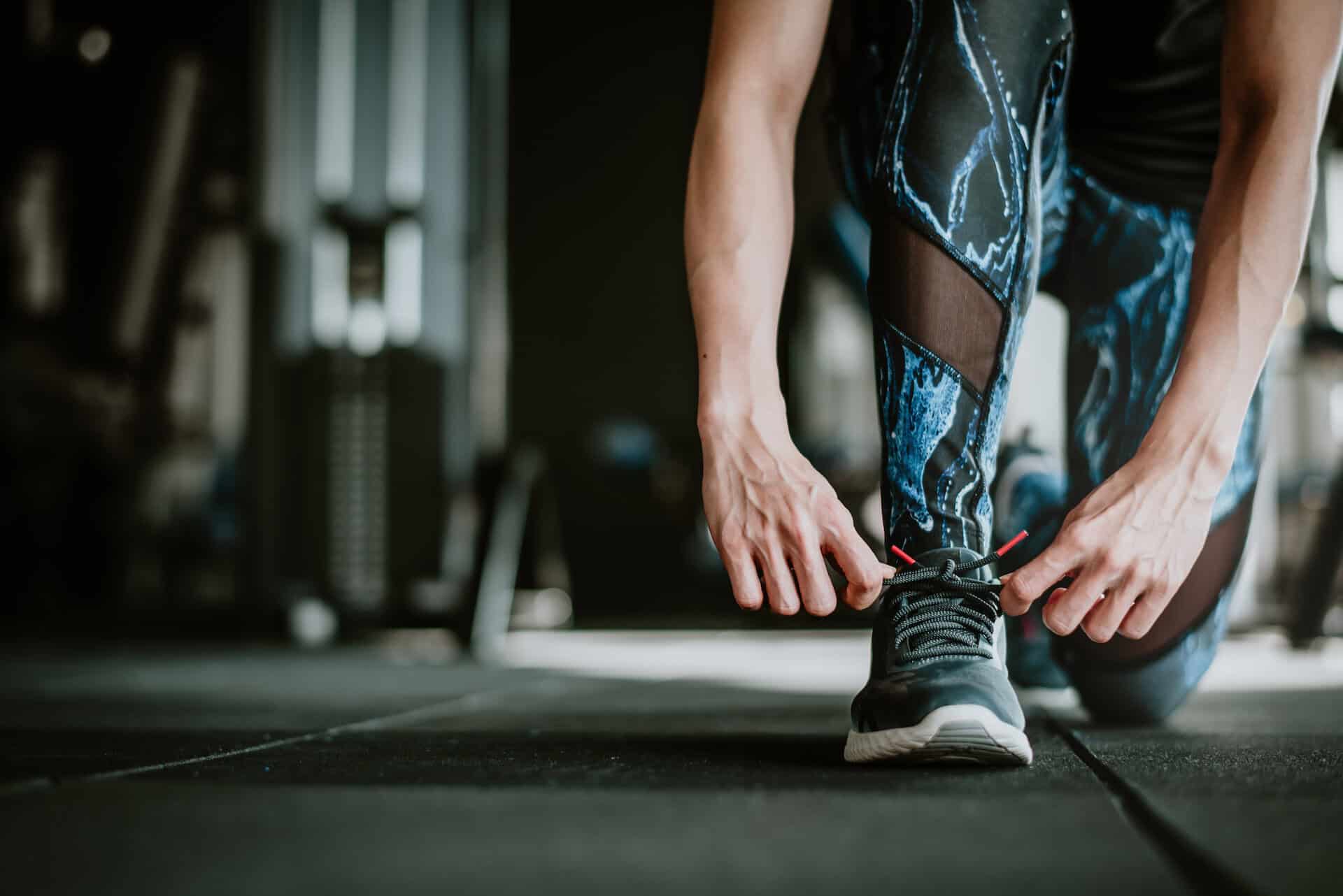 Woman tying her shoelaces before exercise